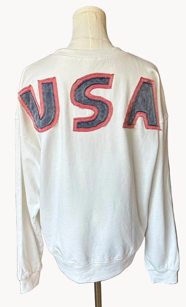 Close-up of a mineral-washed USA vintage pullover featuring an American flag patch on the front, relaxed oversized fit, and soft French terry knit — photographed for Justyna Grace Boutique.