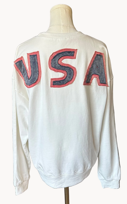 Close-up of a mineral-washed USA vintage pullover featuring an American flag patch on the front, relaxed oversized fit, and soft French terry knit — photographed for Justyna Grace Boutique.