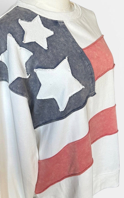 Close up view of women's mineral wash USA pullover with American flag patch.