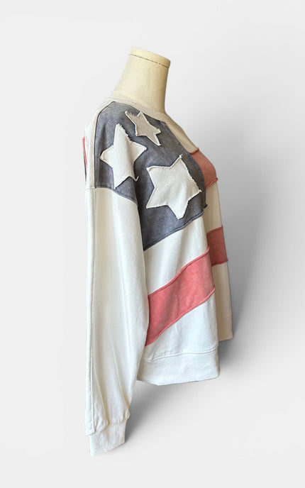 Side view of women's mineral wash USA pullover with American flag patch.