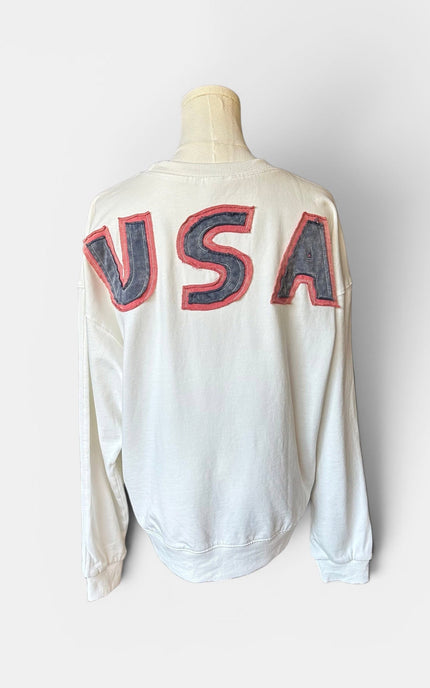 Back view of women's mineral wash USA pullover with American flag patch.