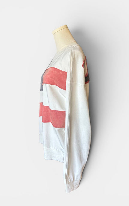 Left side view of women's mineral wash USA pullover with American flag patch.