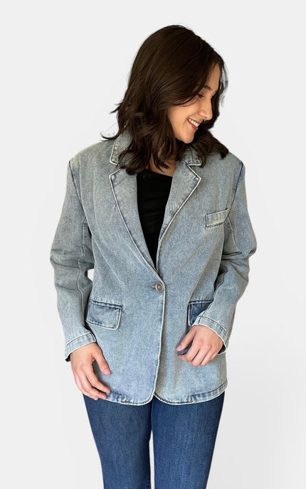 Front view of women's oversized washed denim blazer.
