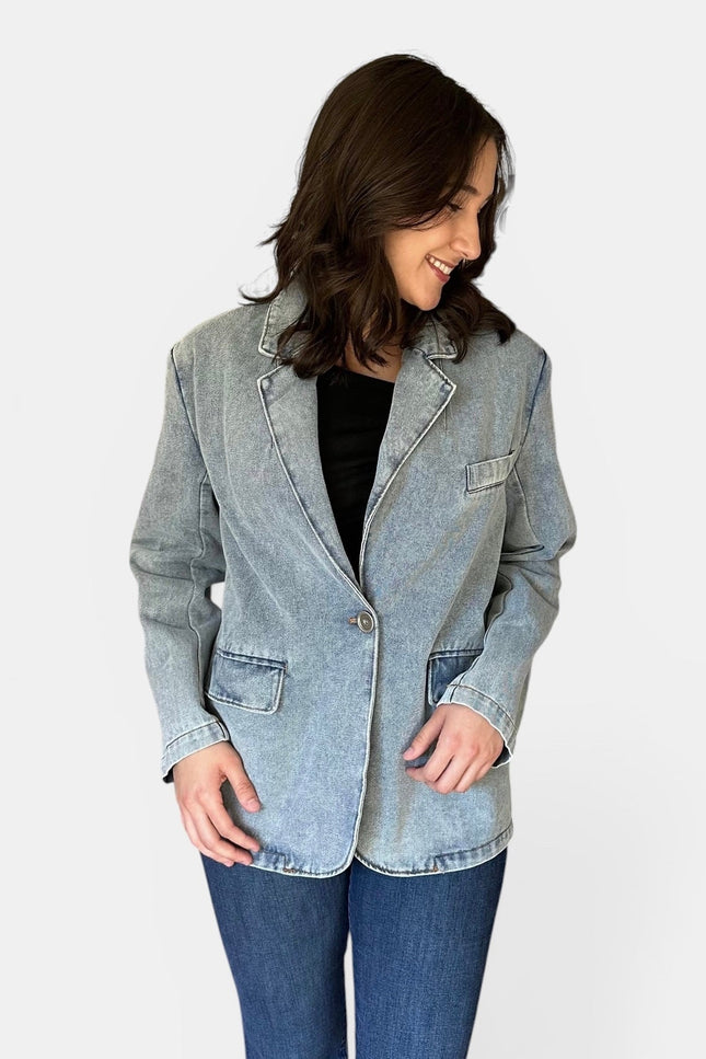 Front view of women's oversized washed denim blazer.