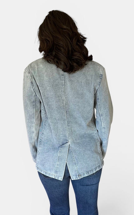 Back view of women's oversized washed denim blazer.