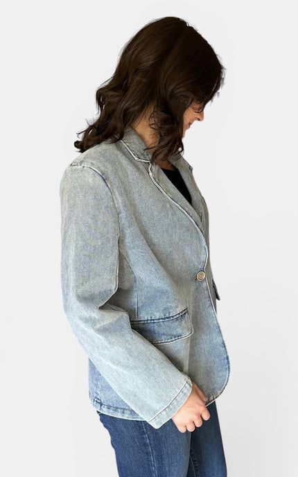 Side profile of women's relaxed fit denim blazer.