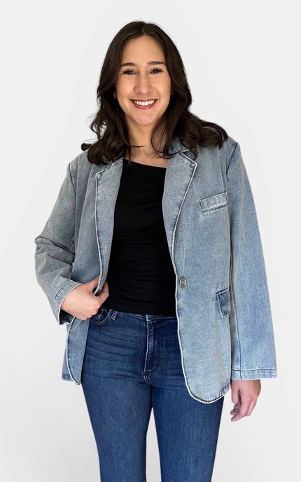 Front view of women's oversized washed denim blazer with notch lapels.