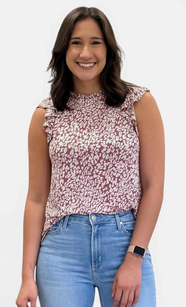 Women's sleeveless abstract animal print knit top with ruffle mock neckline and ruffle cap sleeves.