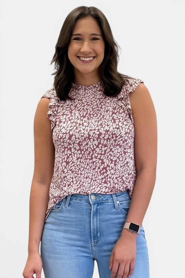 Women's sleeveless abstract animal print knit top with ruffle mock neckline and ruffle cap sleeves.