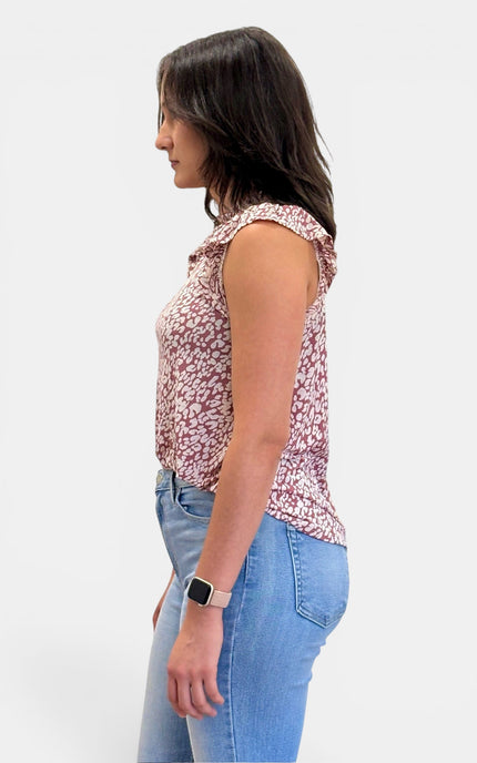 Side view of women's sleeveless abstract animal print knit top featuring ruffle cap sleeves and a relaxed fit.
