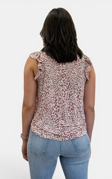 Back view of women's sleeveless abstract animal print knit top with button keyhole closure and straight hem.