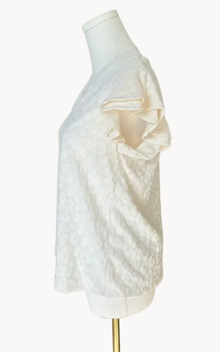 Louisiana Top with subtle tonal animal-print texture, soft ruffle sleeves, and V-neckline – lightweight relaxed silhouette – front view on soft linen background – Justyna Grace Boutique