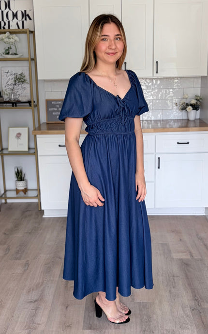 Side view of Arabelle French blue smocked Tencel midi dress with bubble sleeves and A-line skirt