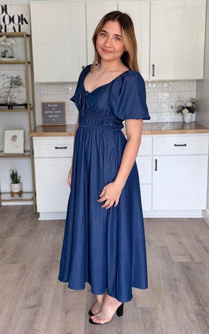 Side view of Arabelle French blue smocked Tencel midi dress with bubble sleeves and A-line skirt