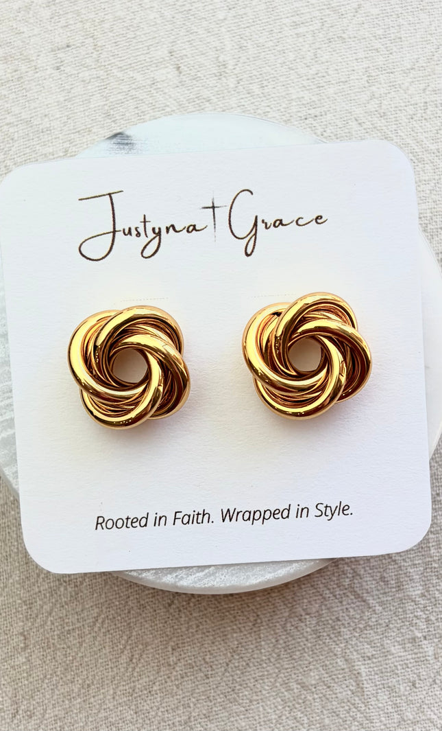 Aurelia gold knot stud earrings on soft linen background with warm natural light, timeless everyday jewelry