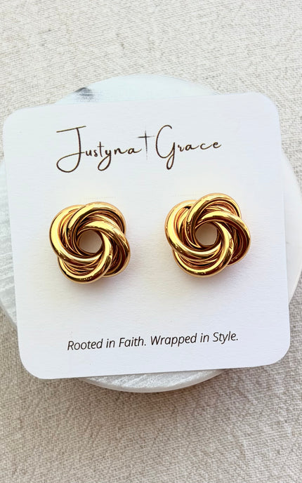 Aurelia gold knot stud earrings on soft linen background with warm natural light, timeless everyday jewelry