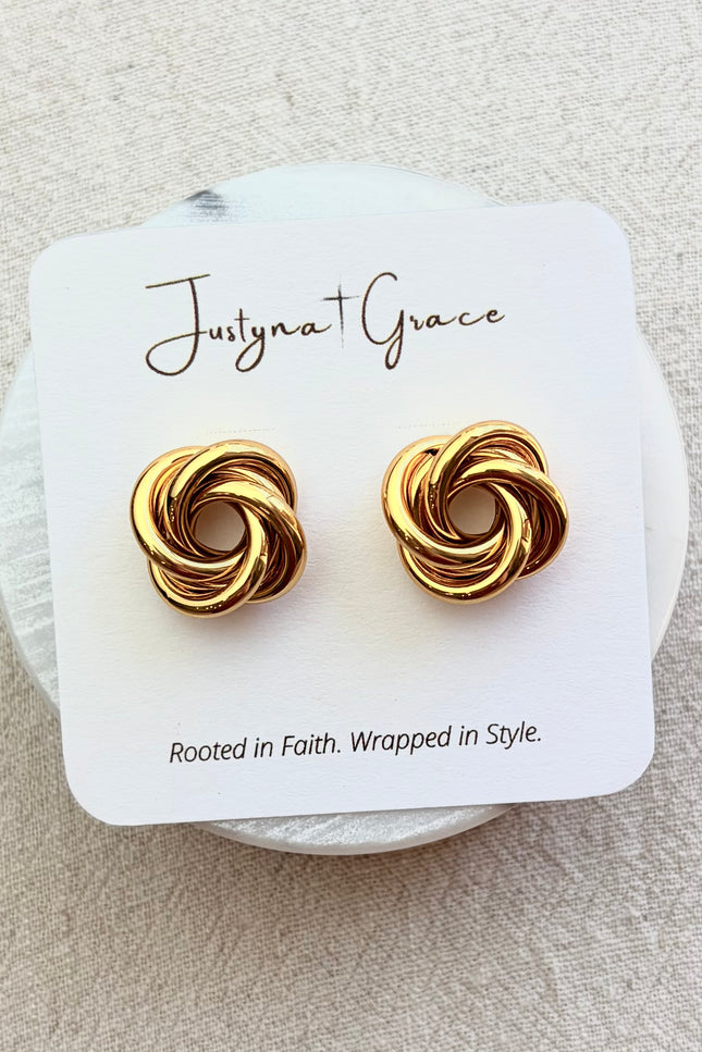 Aurelia gold knot stud earrings on soft linen background with warm natural light, timeless everyday jewelry