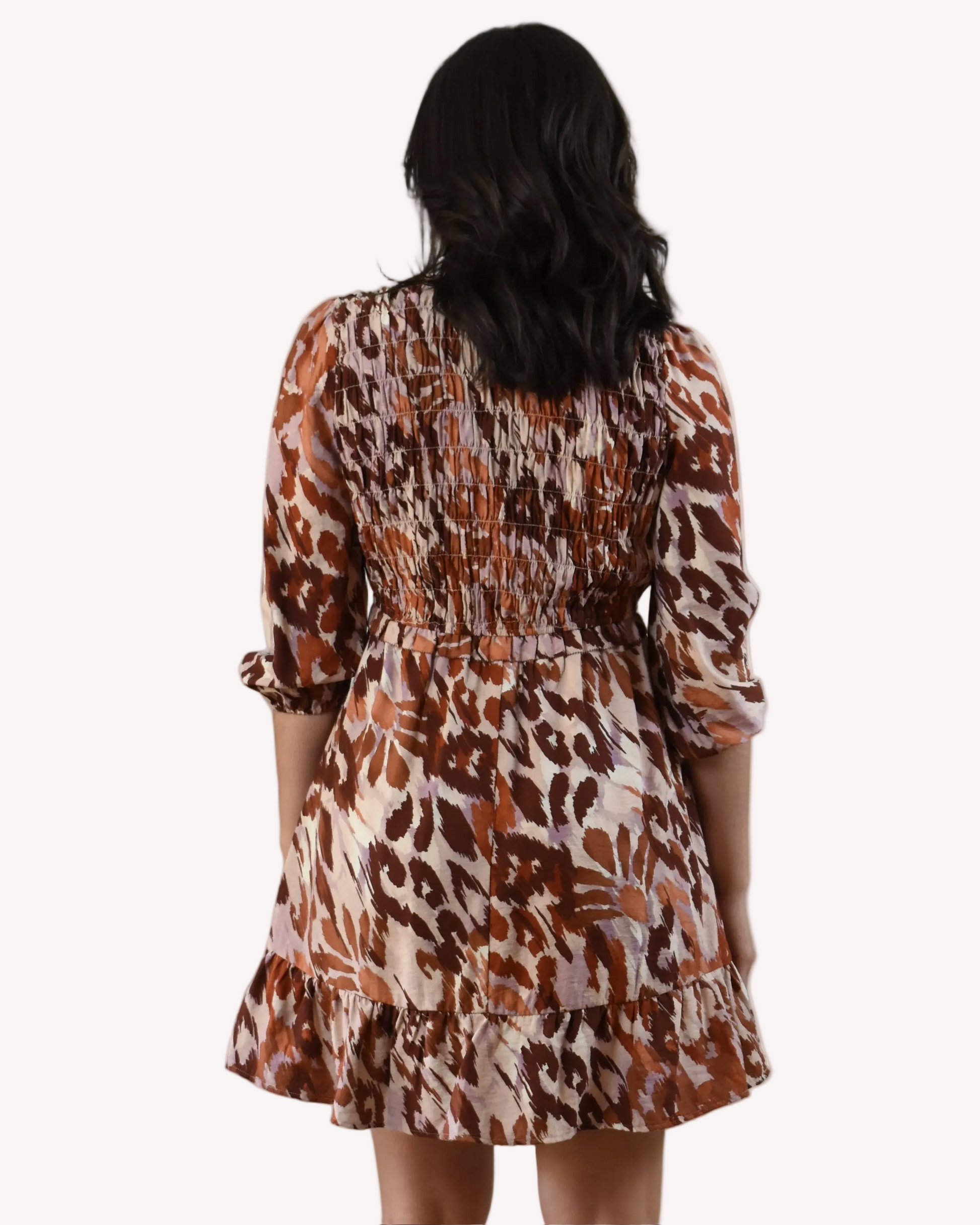 The Autumn Whisper Smocked Mini Dress in nude and brown — lightweight crinkle gauze with ruffle trim and smocked bodice from Justyna Grace Boutique.