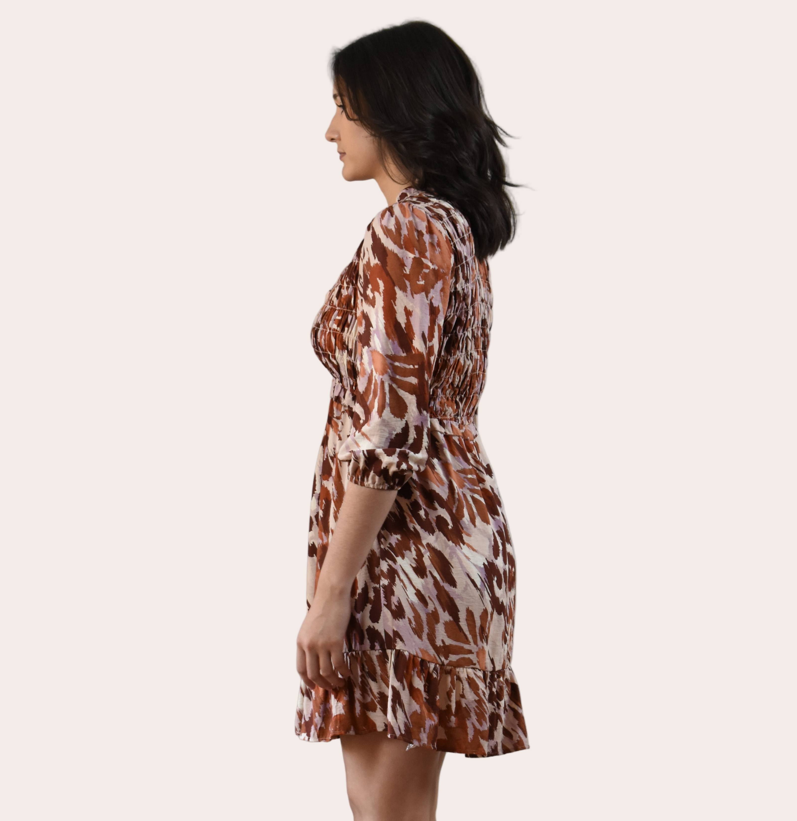 The Autumn Whisper Smocked Mini Dress in nude and brown — lightweight crinkle gauze with ruffle trim and smocked bodice from Justyna Grace Boutique.