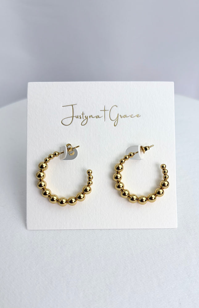 Beaded hoop earrings in 18k gold PVD over 316L stainless steel with textured beaded design and polished finish