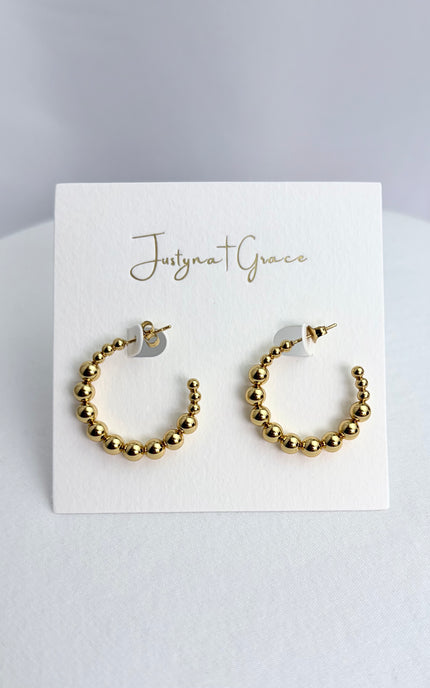 Beaded hoop earrings in 18k gold PVD over 316L stainless steel with textured beaded design and polished finish