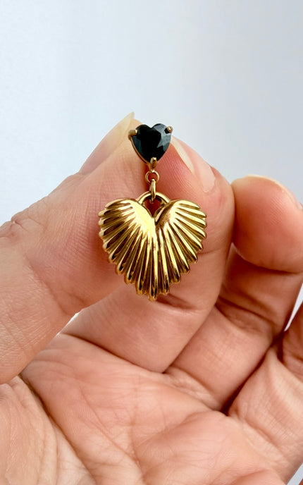 Close-up of black cubic zirconia heart and textured gold drop earring showing 18k gold PVD finish and dimensional detail