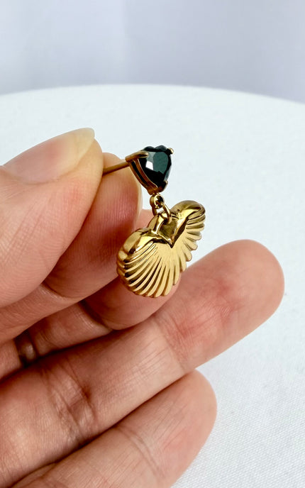 Close-up of black cubic zirconia heart and textured gold drop earring showing 18k gold PVD finish and dimensional detail