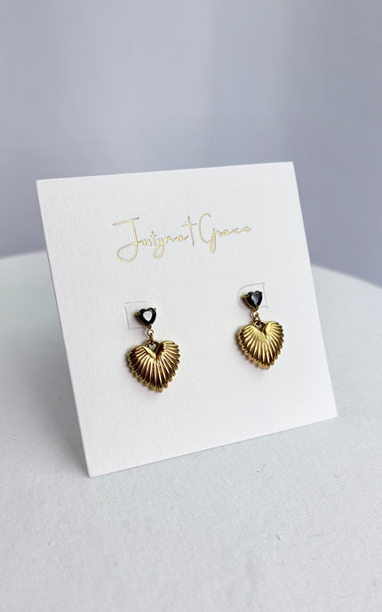 Side profile of black crystal heart drop earring showing textured gold drop detail and lightweight stainless steel construction