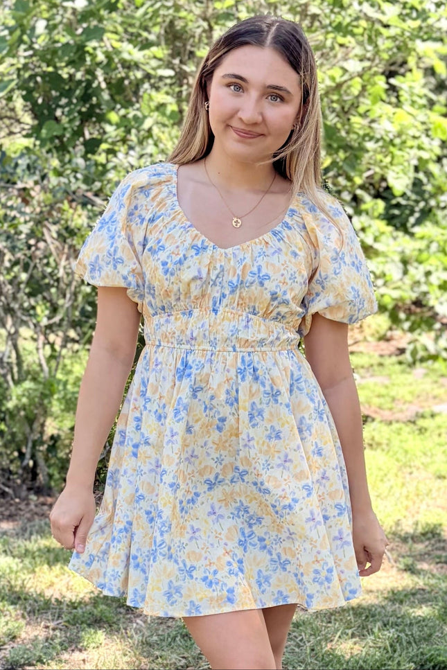 Woman in Bloom Bubble Sleeve Dress styled casually with simple sandals for spring garden setting, showcasing comfortable elasticated waist and airy cotton fabric