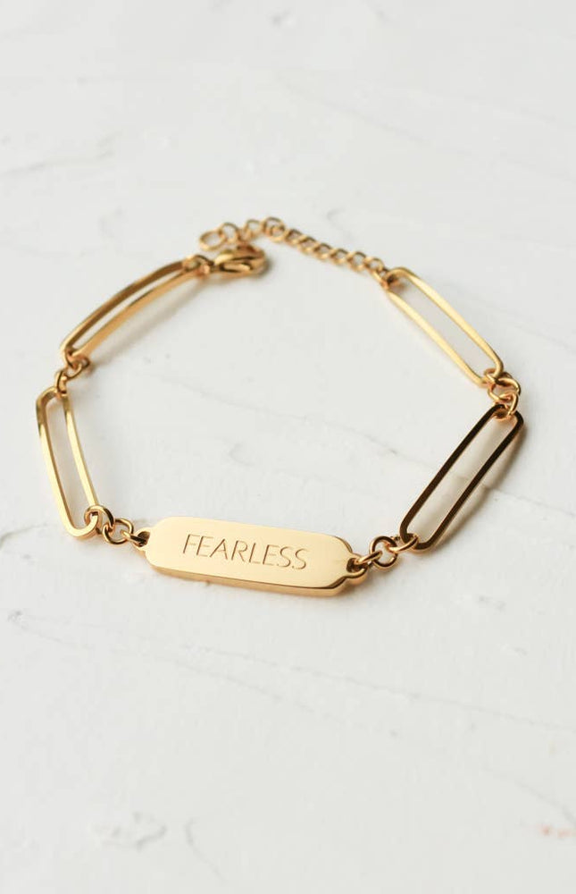 Bold in Spirit Bracelet — 14K gold-plated stainless steel bracelet engraved with “Fearless,” ethically made by survivors from Justyna Grace Boutique.