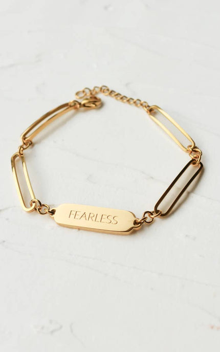 Bold in Spirit Bracelet — 14K gold-plated stainless steel bracelet engraved with “Fearless,” ethically made by survivors from Justyna Grace Boutique.