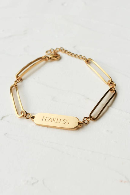 Bold in Spirit Bracelet — 14K gold-plated stainless steel bracelet engraved with “Fearless,” ethically made by survivors from Justyna Grace Boutique.