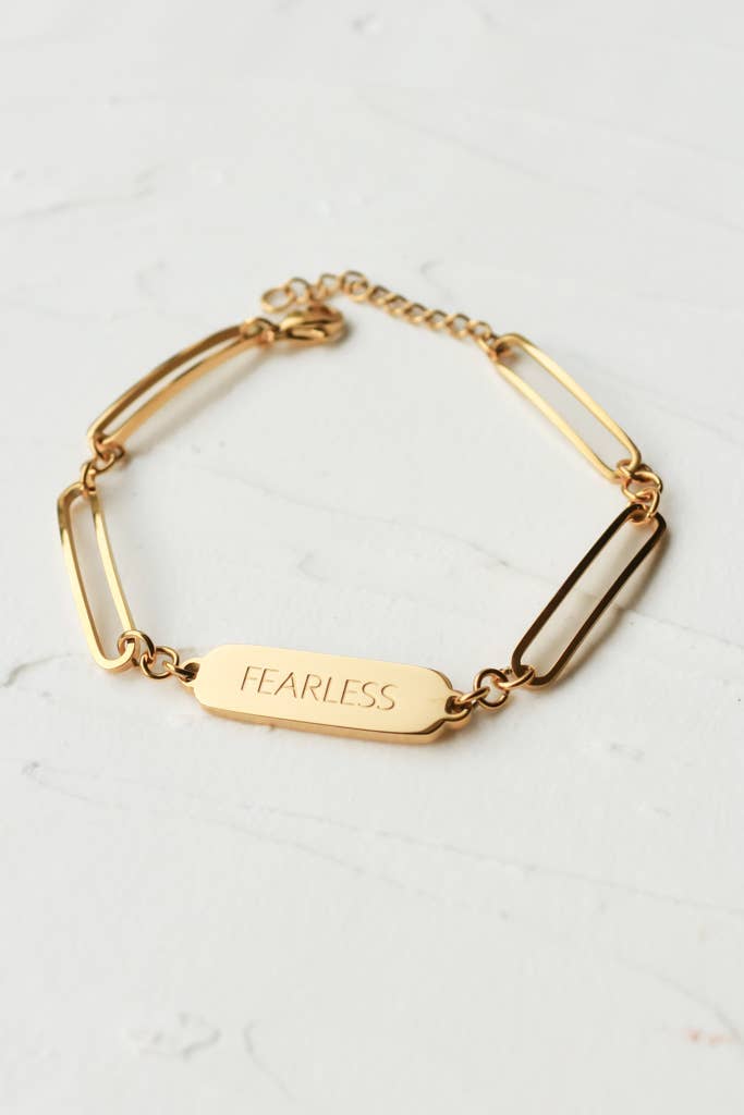 Bold in Spirit Bracelet — 14K gold-plated stainless steel bracelet engraved with “Fearless,” ethically made by survivors from Justyna Grace Boutique.