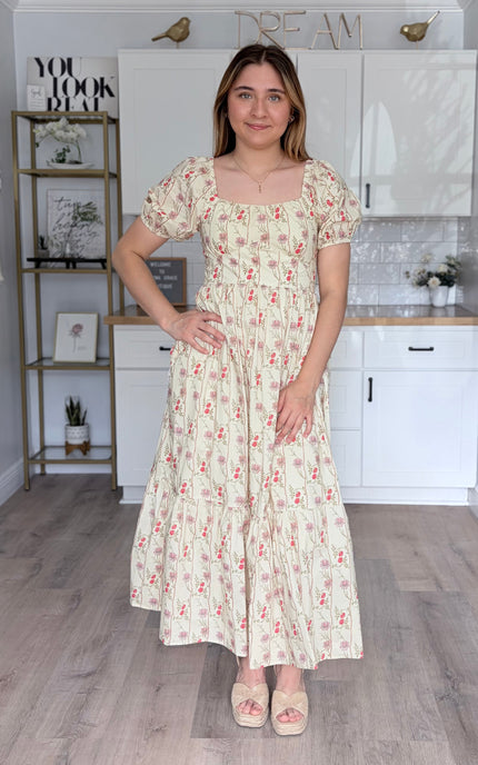 Feminine floral maxi dress with fitted waist and tiered hem