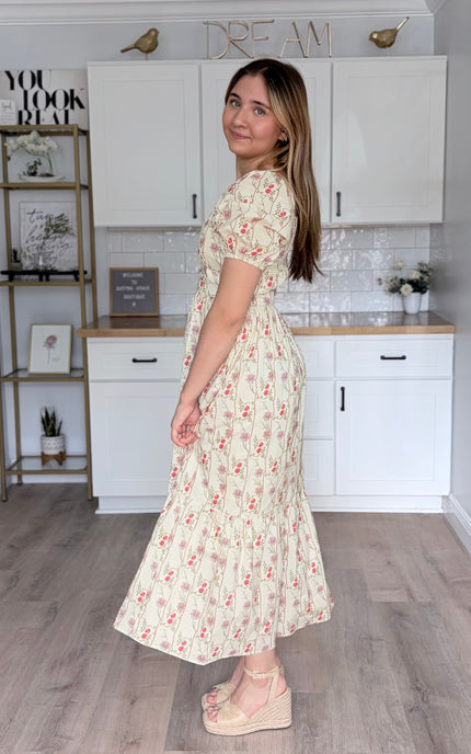 Feminine floral maxi dress with fitted waist and tiered hem