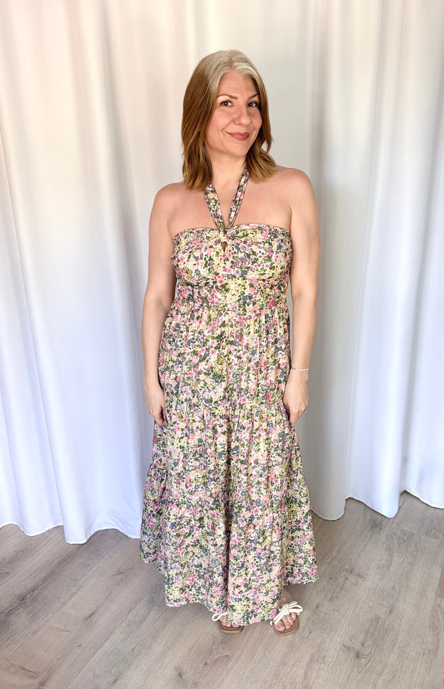 Full-length front view of the Catalina Floral Knot Maxi Dress from Justyna Grace Boutique, showcasing the vibrant floral print and elegant tiered skirt.