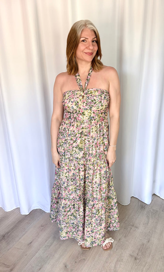Full-length front view of the Catalina Floral Knot Maxi Dress from Justyna Grace Boutique, showcasing the vibrant floral print and elegant tiered skirt.