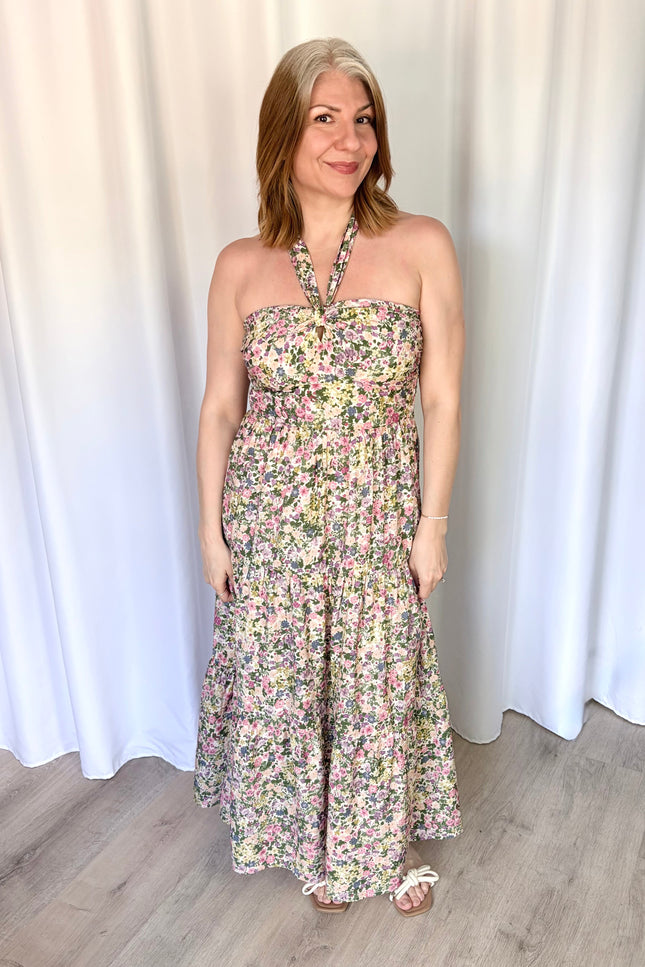 Full-length front view of the Catalina Floral Knot Maxi Dress from Justyna Grace Boutique, showcasing the vibrant floral print and elegant tiered skirt.