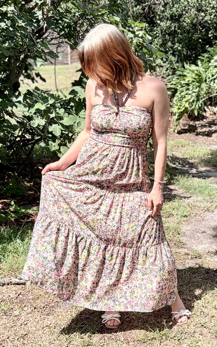 Candid outdoor shot of the Catalina Floral Maxi Dress in motion, showing the elegant, breezy flare of the tiered skirt.