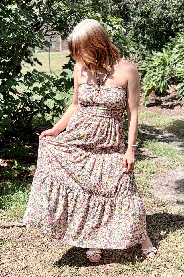 Candid outdoor shot of the Catalina Floral Maxi Dress in motion, showing the elegant, breezy flare of the tiered skirt.