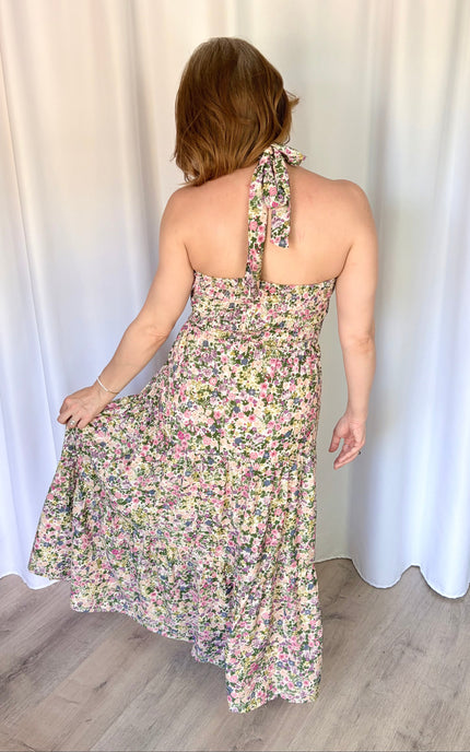 Back view of the Catalina Floral Maxi Dress highlighting the adjustable halter neck tie and flexible smocked back panel.