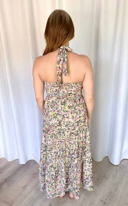 Back view of the Catalina Floral Maxi Dress highlighting the adjustable halter neck tie and flexible smocked back panel.