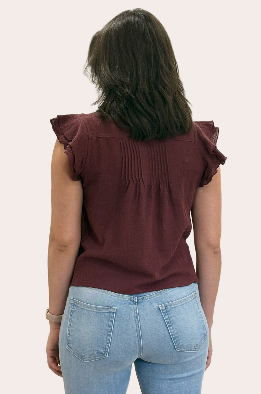 The Clara Pintuck Ruffle Top — lightweight 100% cotton blouse with ruffle neckline and button front from Justyna Grace Boutique.