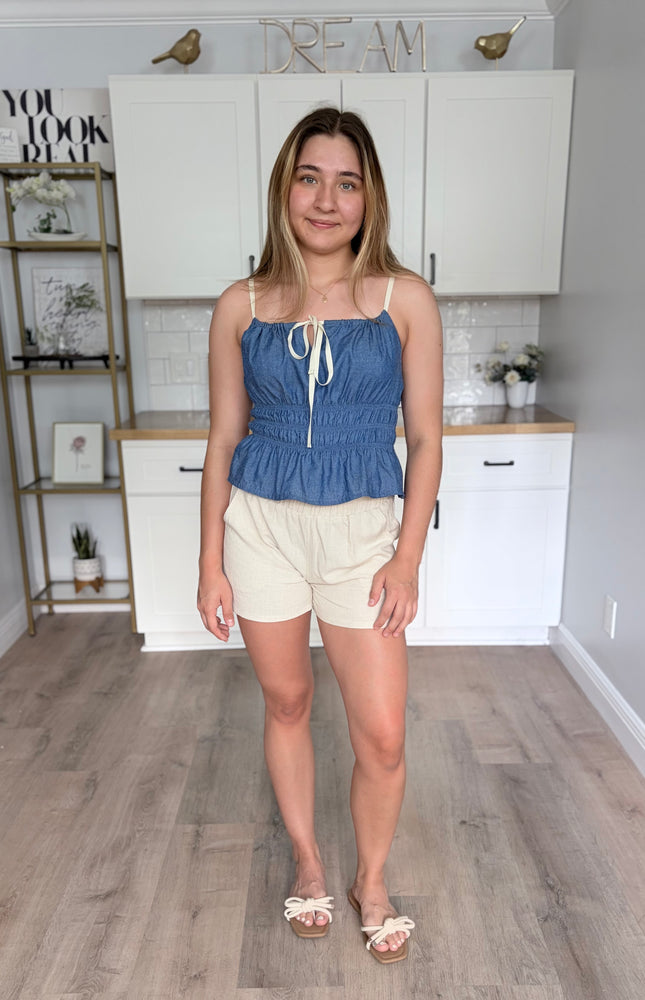 Soft, breathable linen blend shorts with a relaxed fit, elastic ruffle waistband, and side pockets, perfect for warm-weather everyday wear