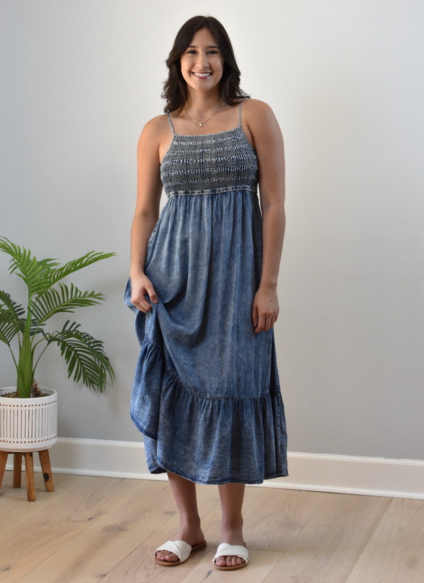 Blue washed Tencel midi dress with smocked top and tiered skirt — relaxed coastal charm from Justyna Grace Boutique.