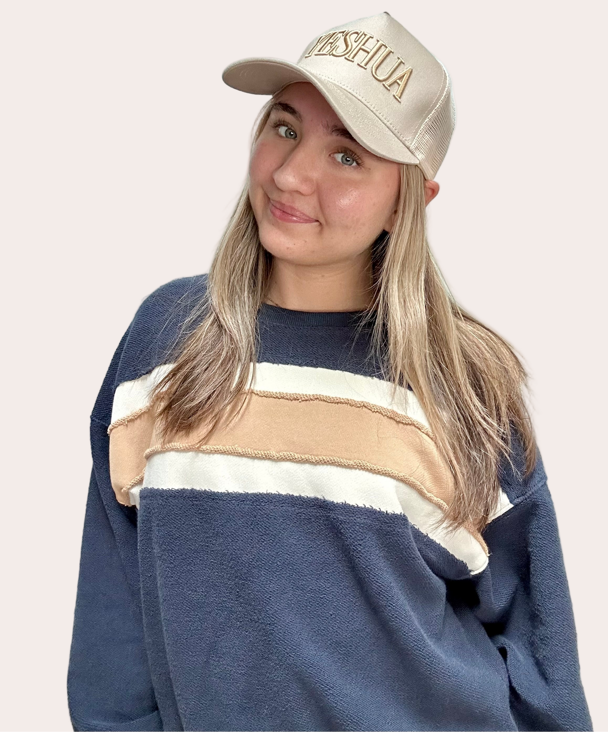 Cozy pullover sweatshirt with a relaxed fit, dropped dolman sleeves, and a bold contrast stripe detail, photographed on a soft-linen background.