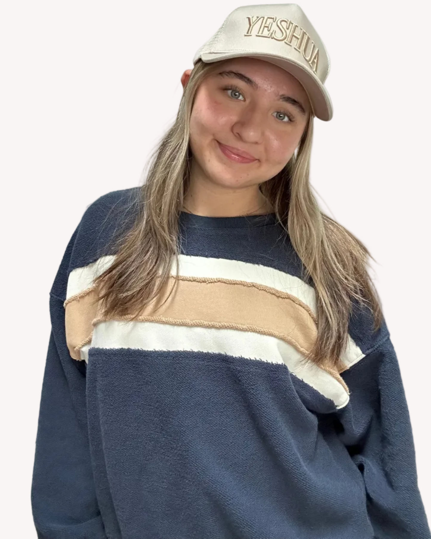 Cozy pullover sweatshirt with a relaxed fit, dropped dolman sleeves, and a bold contrast stripe detail, photographed on a soft-linen background.