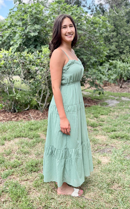 Fit and flare summer dress with a square neckline and hidden side pockets, styled for a modern feminine aesthetic.