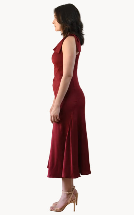 Cranberry Grace Dress with one-shoulder bow detail, slanted seamwork, and flared midi hem, designed for elegant movement, photographed on Soft Linen background.
