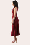 Cranberry Grace Dress with one-shoulder bow detail, slanted seamwork, and flared midi hem, designed for elegant movement, photographed on Soft Linen background.